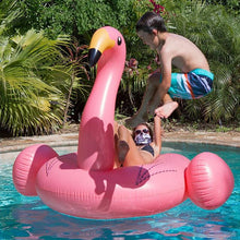 child jumping into pool with woman on flamingo float in bad hombre neck gaiter faceshield