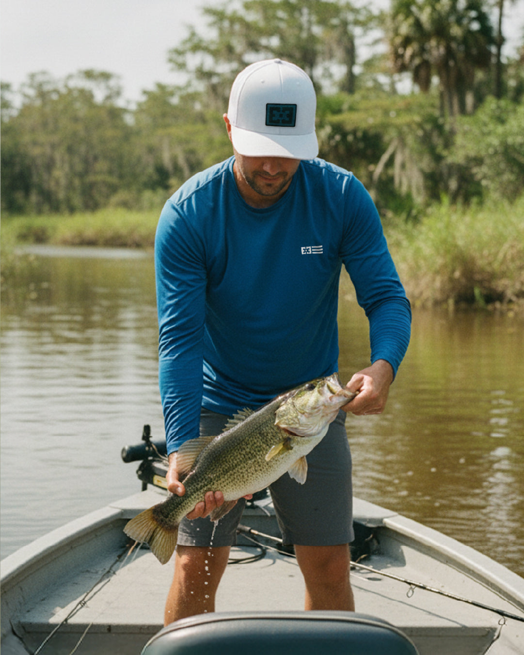 Man on a boat holding a fish