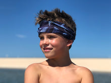 youth boy with sandy hair wearing shark bait neck gaiter headband