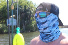 man wearing blue scales neck gaiter mask on everglades boat with fishing poles