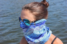woman with ocean reflection in sunglasses wearing waves neck gaiter mask